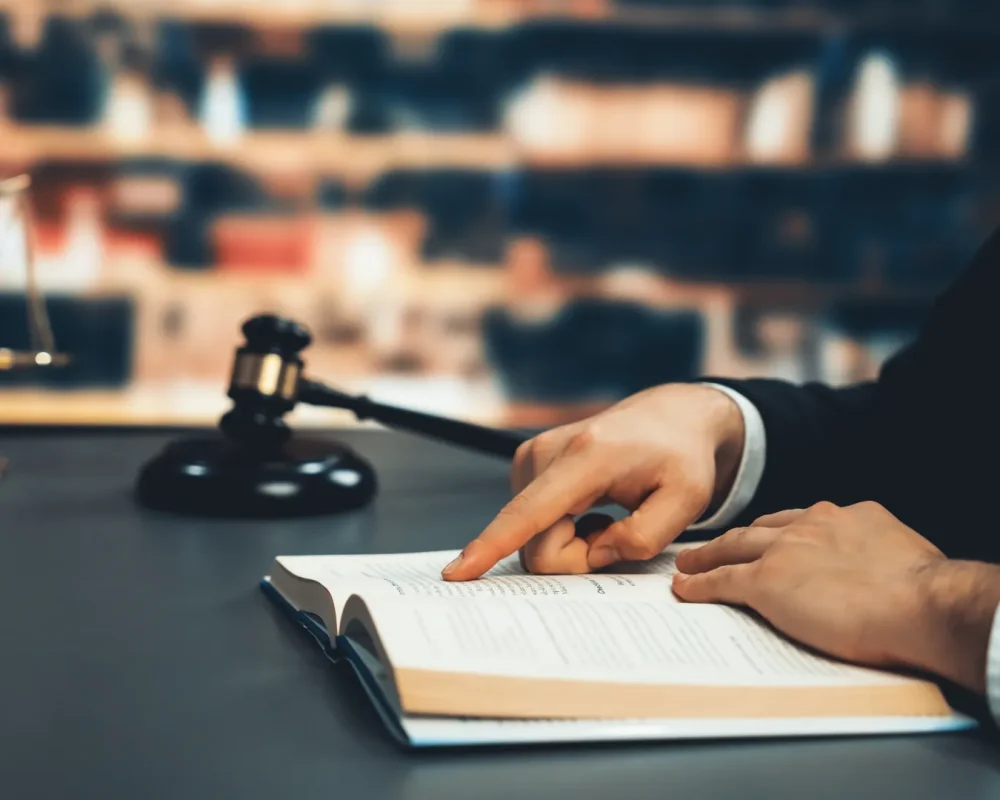 compressed_closeup-lawyer-reading-studying-legal-book-library-equilibrium